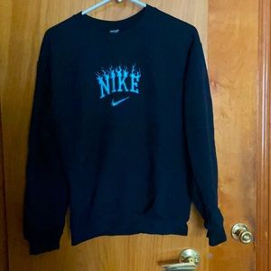 Black Nike crew neck with flame symbol